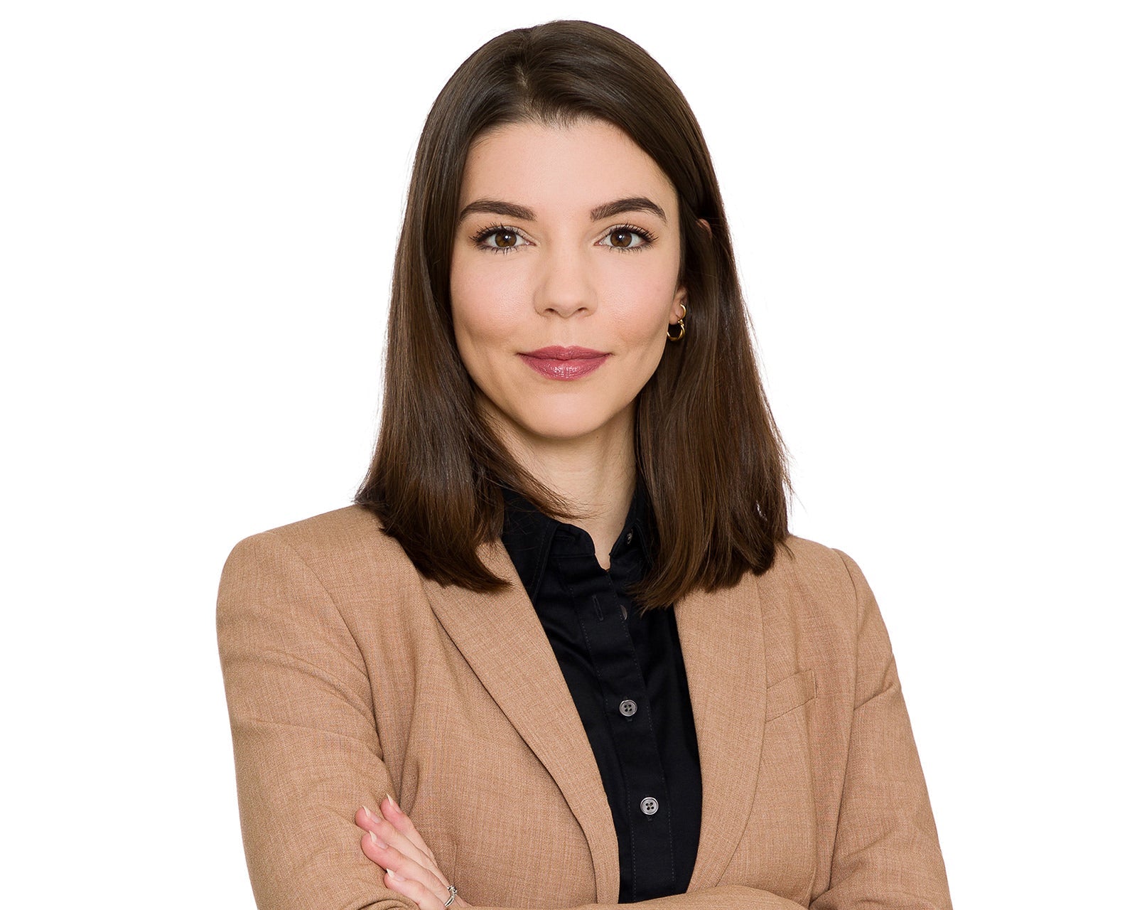 Corporate headshot of a businesswoman in a tan blazer on a clean white background