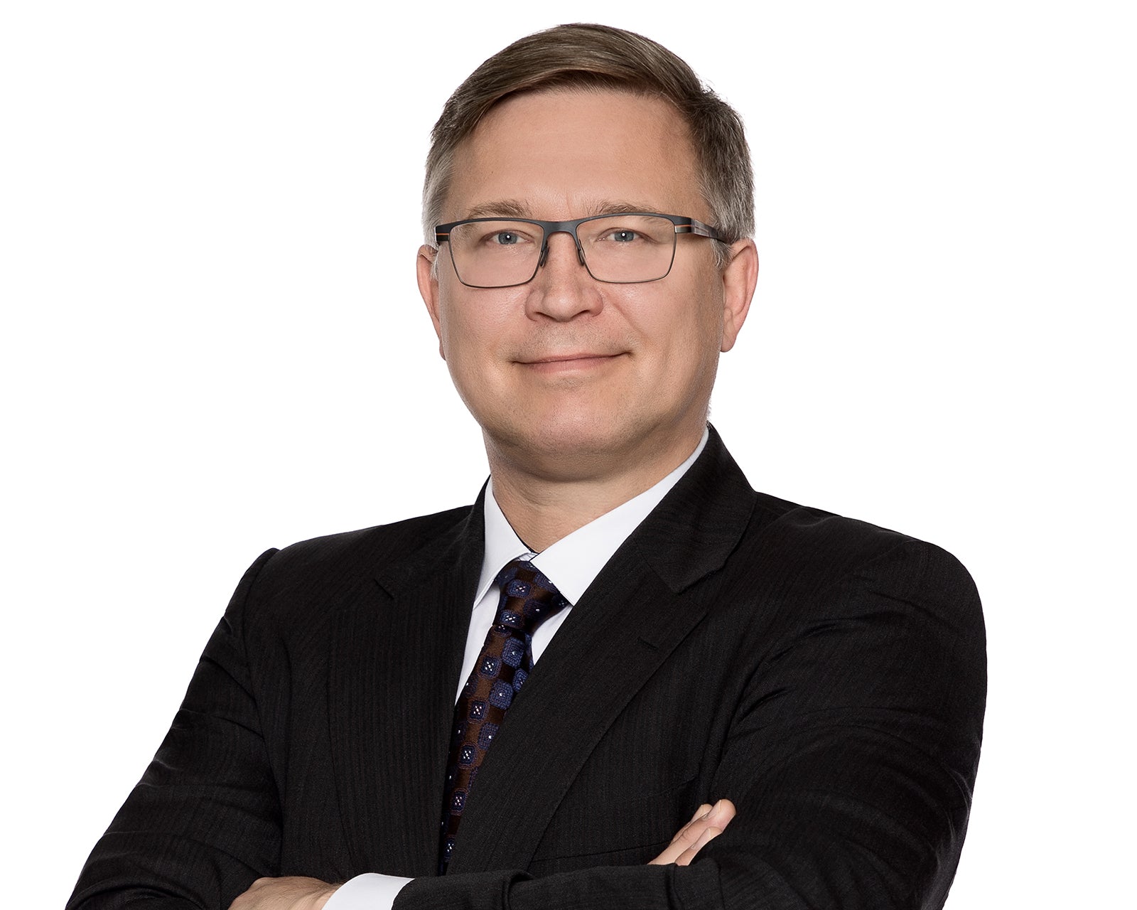 Corporate headshot of a professional on a clean white background, evenly lit and cropped head-and-shoulders