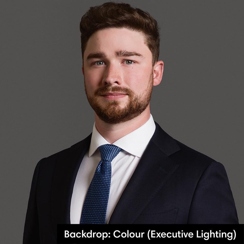 Business portrait with executive lighting and colour backdrop