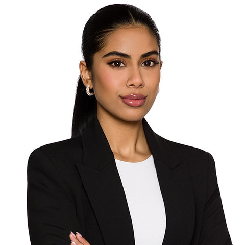 Law firm headshot of a woman lawyer in a black blazer, photographed on the firm's white-background standard
