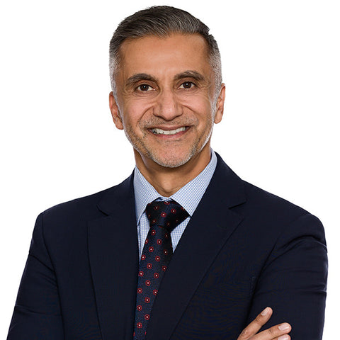 Law firm headshot of a partner in a navy suit and patterned tie on the white-background standard